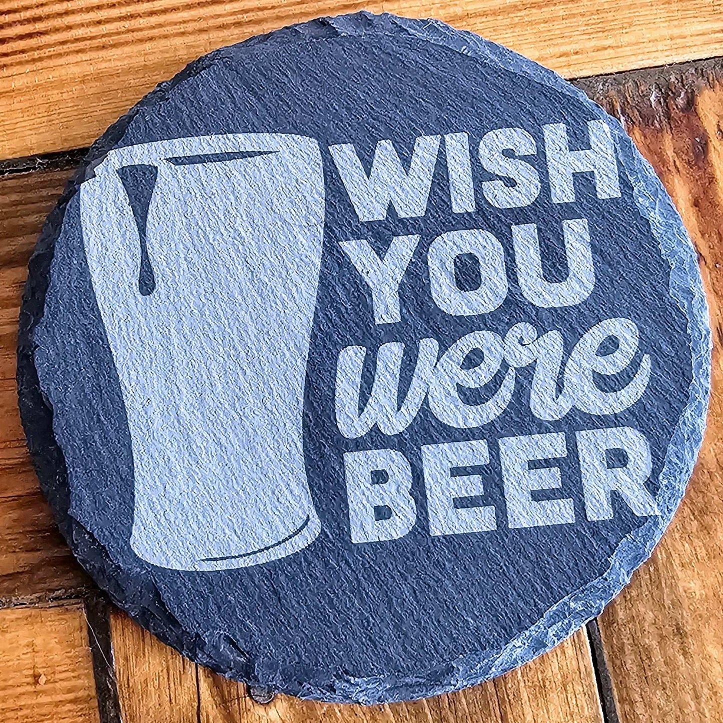 a slate sign that says wish you were beer