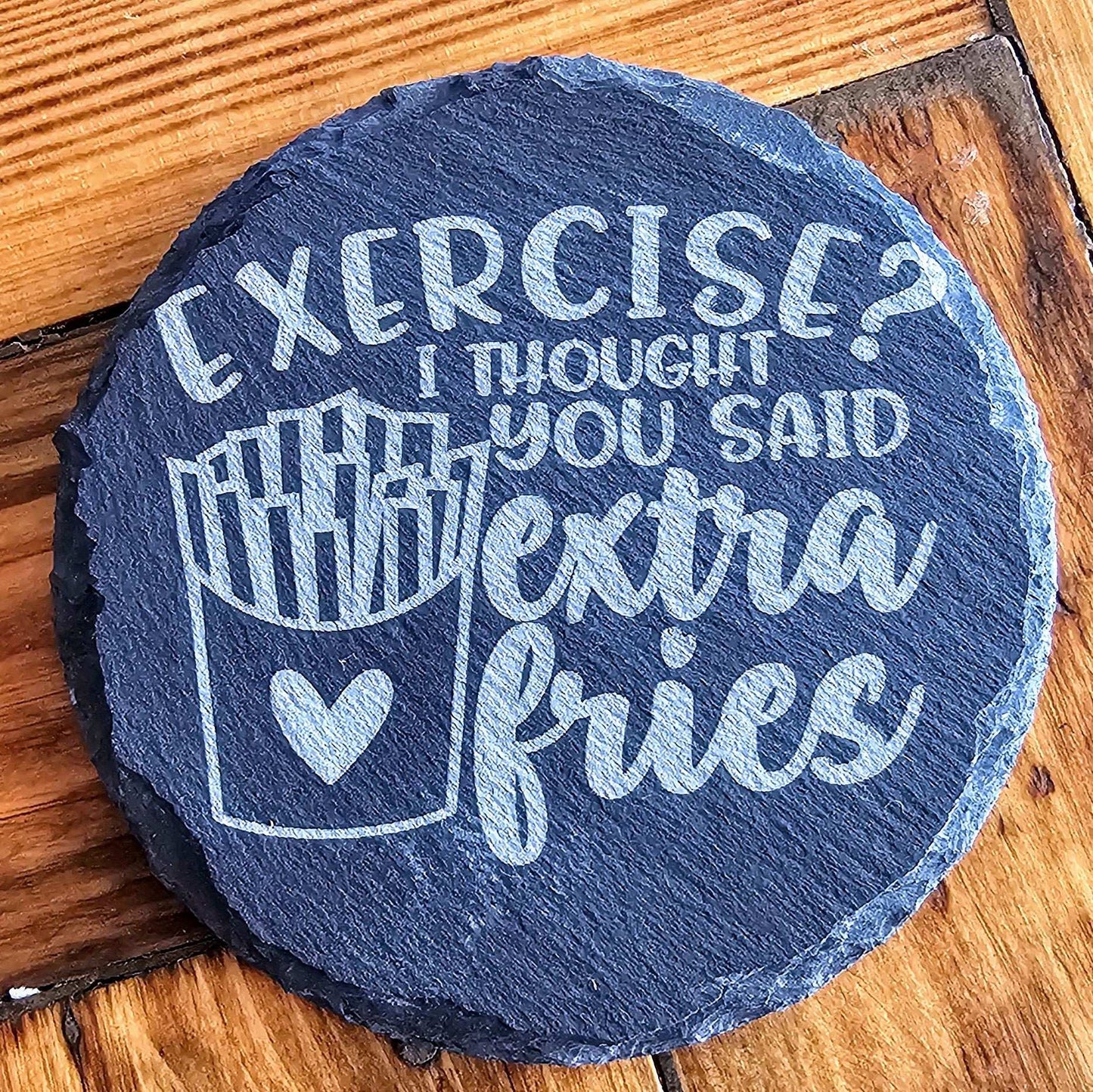 a slate sign that says exercise? i thought you said with extra fries