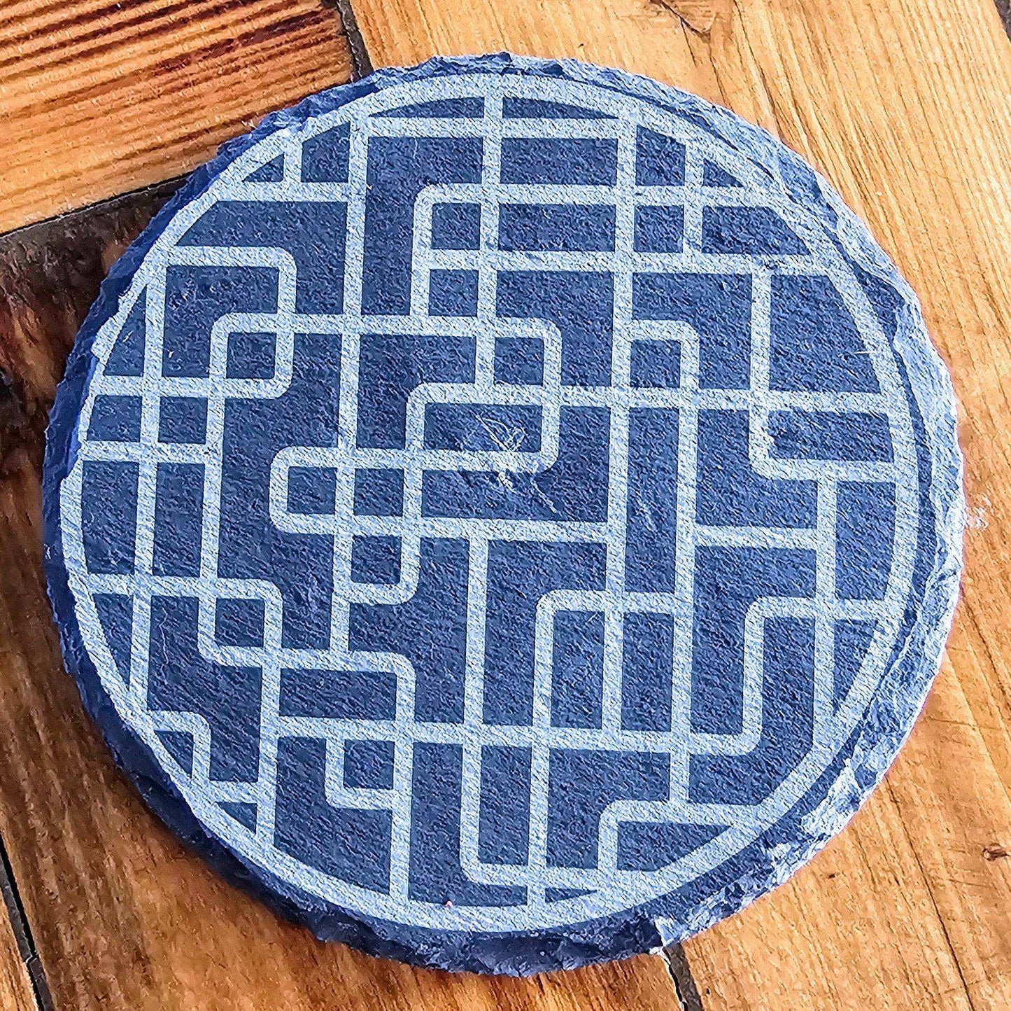 a blue and white circular object sitting on top of a wooden floor