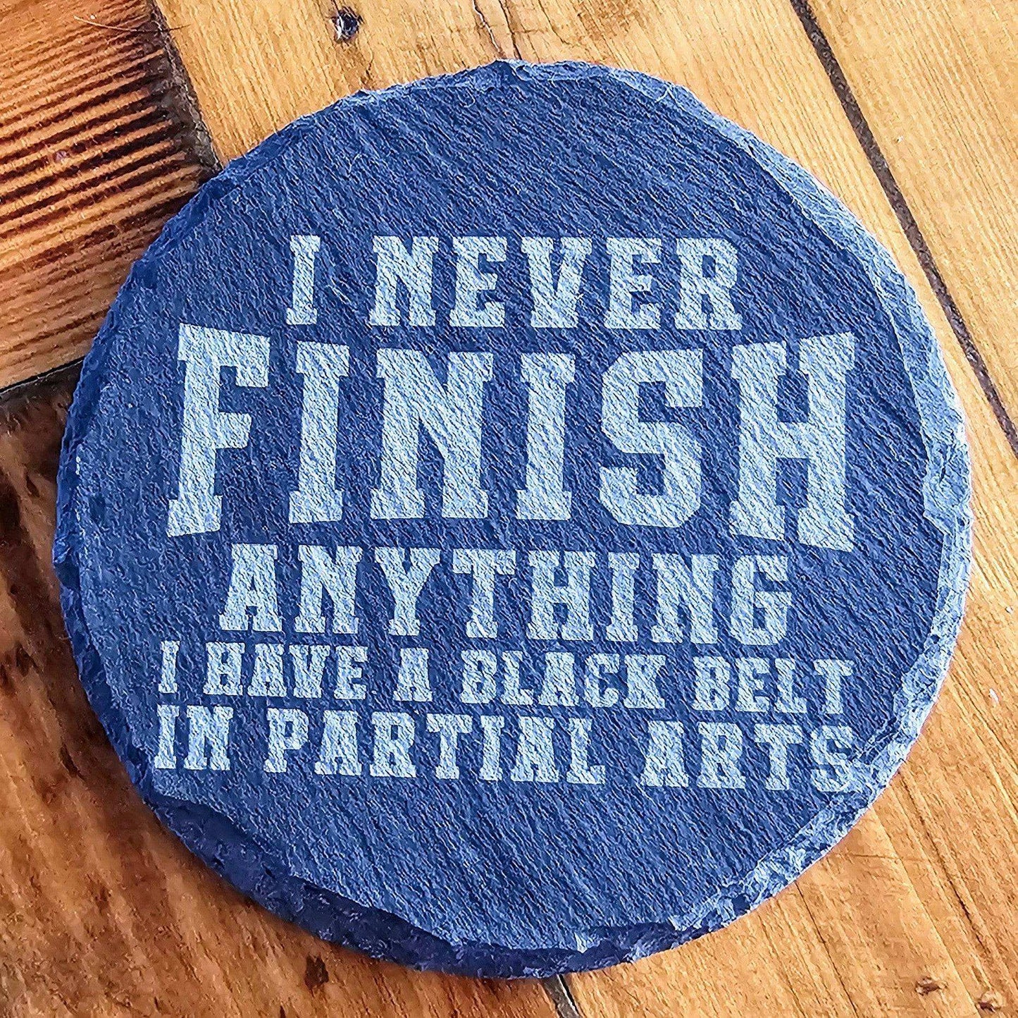 a blue stone that says i never finish anything i have a black belt in partial