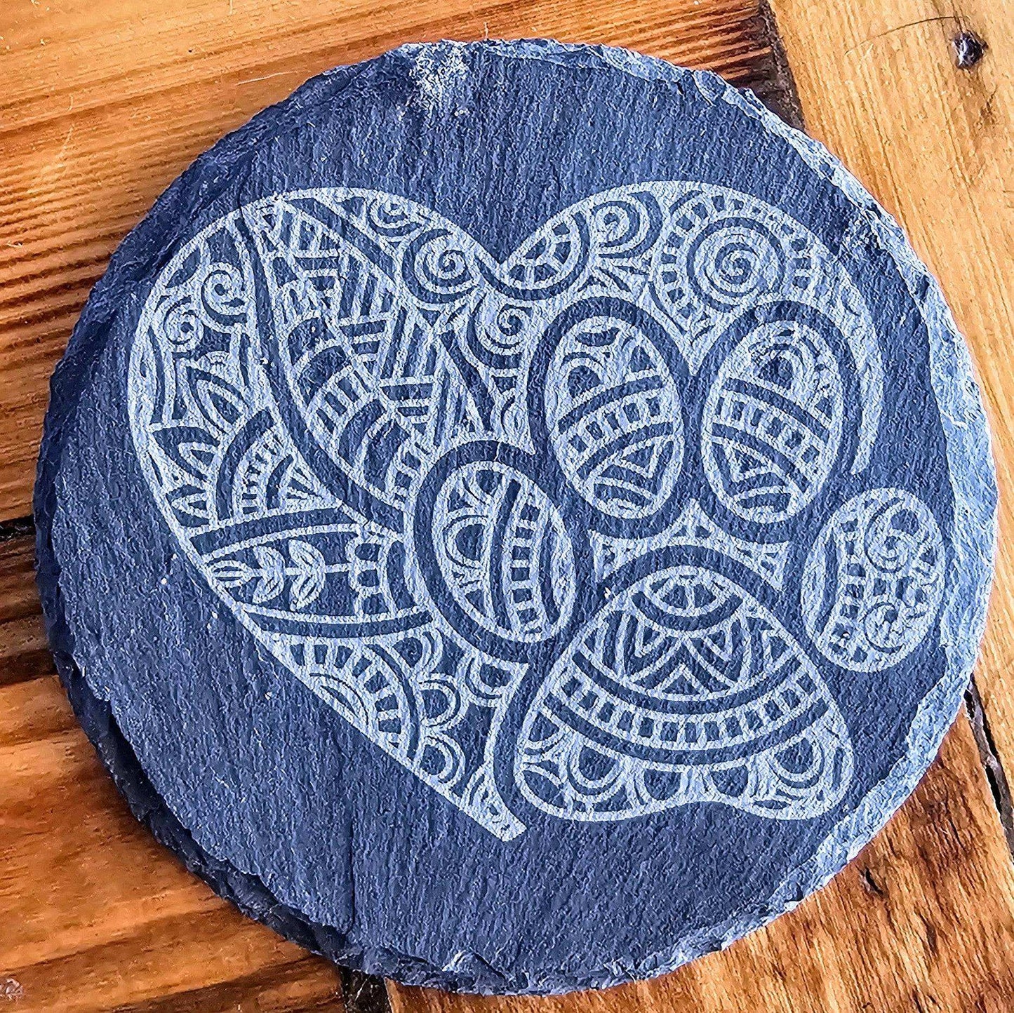 a stone with a heart on it on a wooden table
