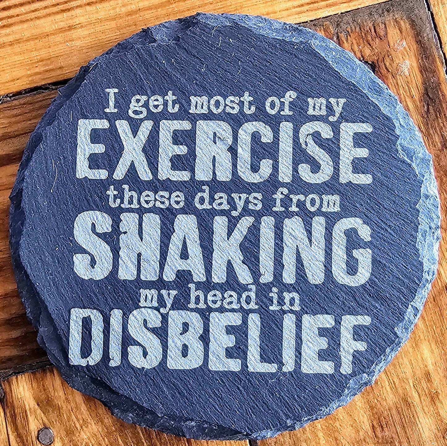 a slate sign that says i get most of my exercise these days from shaking my