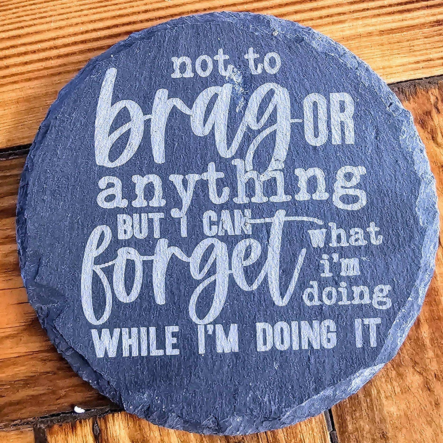 a stone with a quote on it on a wooden surface