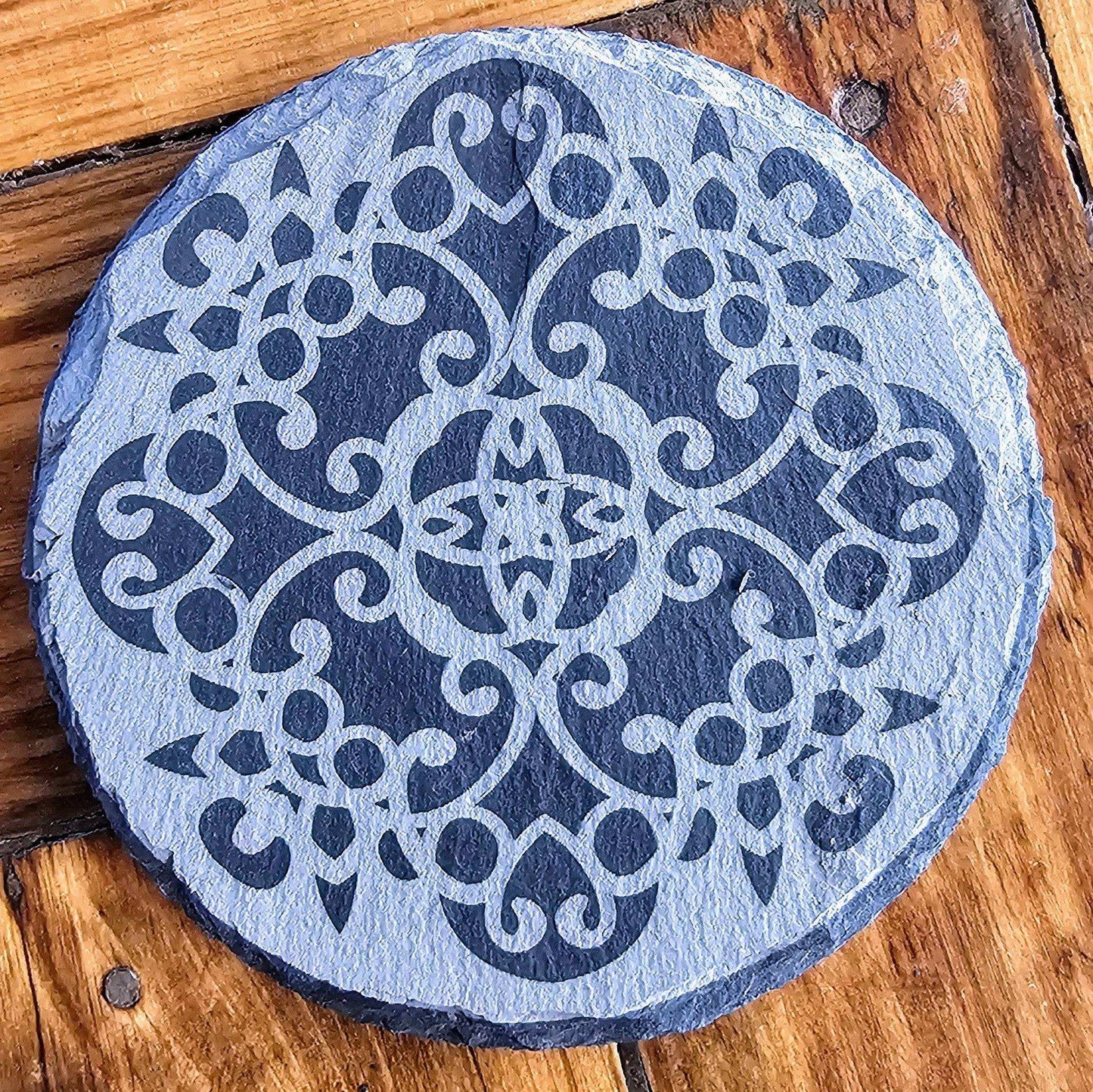 a blue and white stone sitting on top of a wooden floor