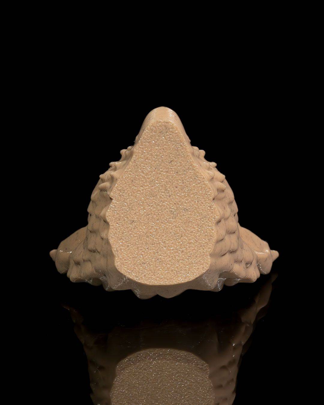 a white object sitting on top of a black surface