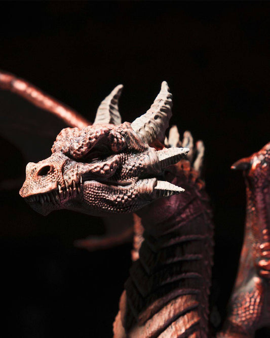 a close up of a dragon figurine on a black background