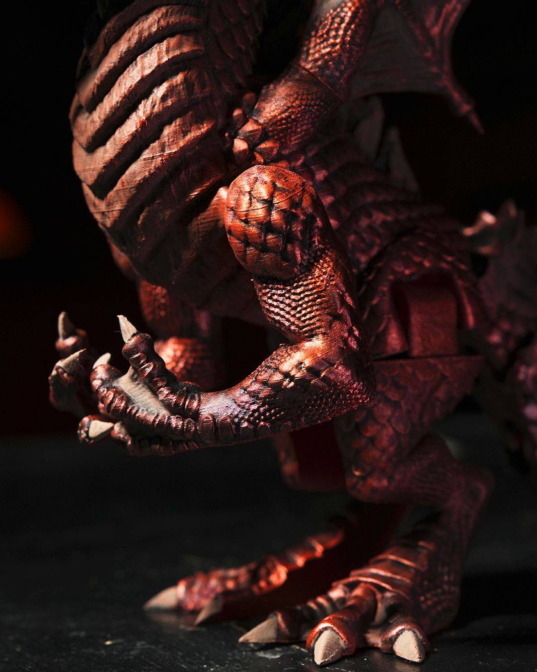 a close up of a toy dragon on a table