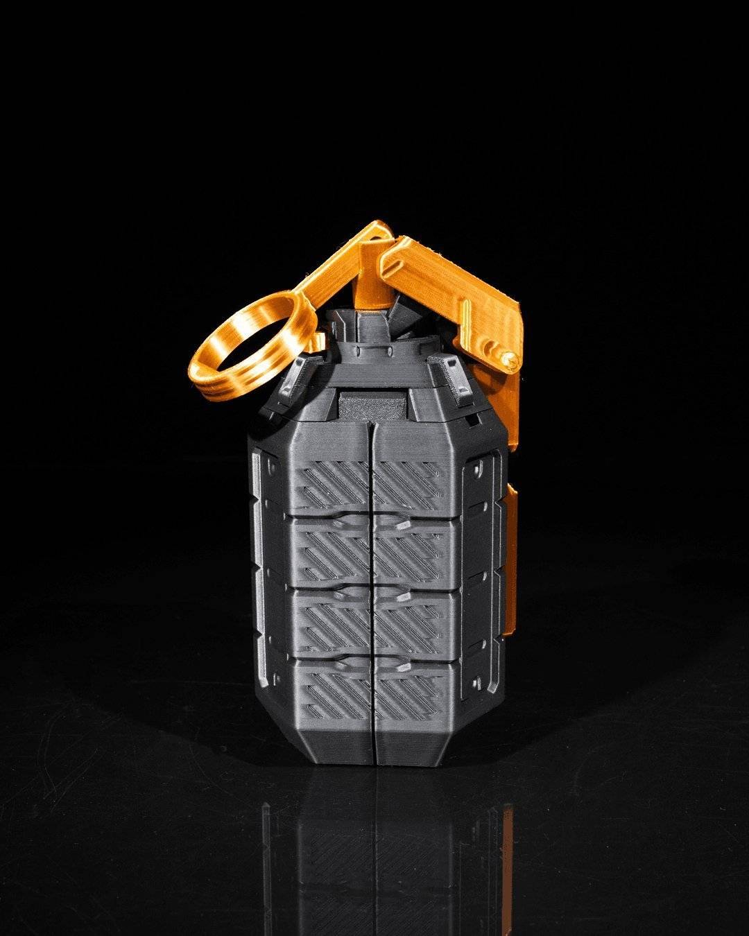 a metal object with a yellow handle on a black surface