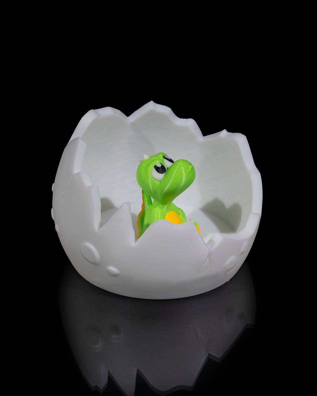 an egg shell with a small toy in it