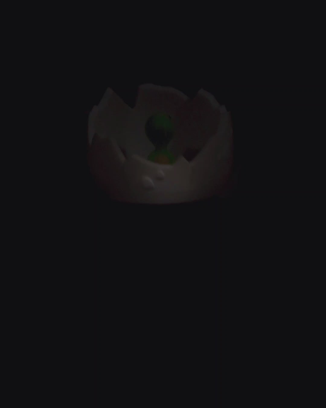 a black background with a green light in the middle of it