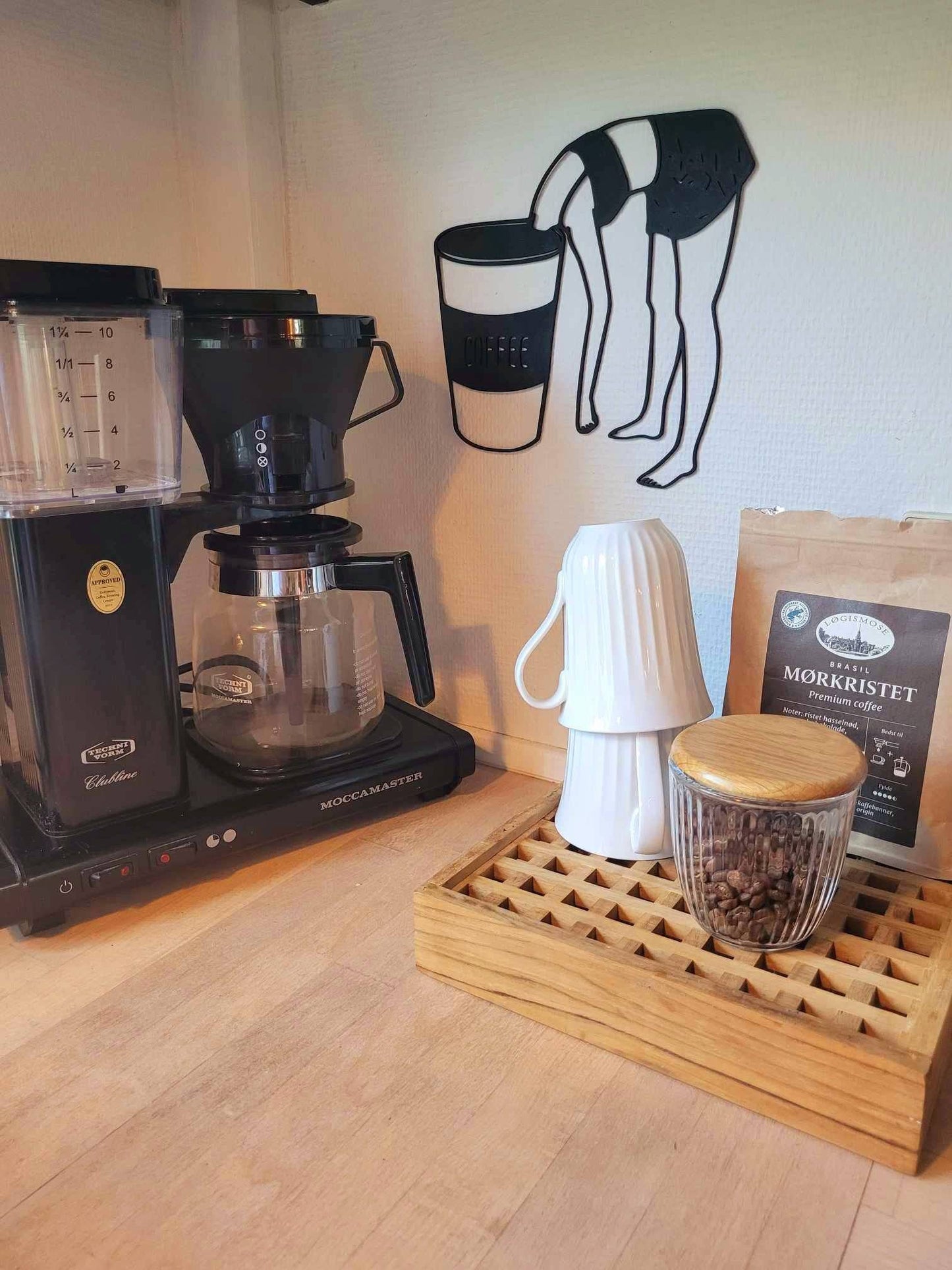 a coffee maker sitting on top of a wooden tray